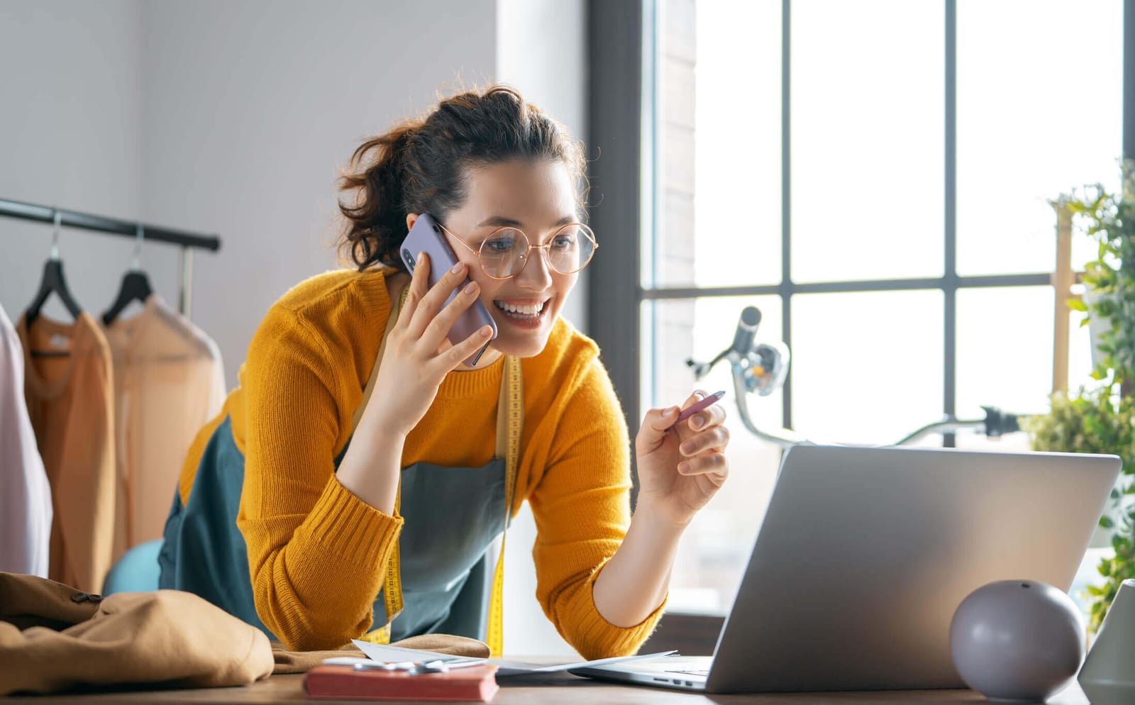 A small business owner on the phone at her laptop