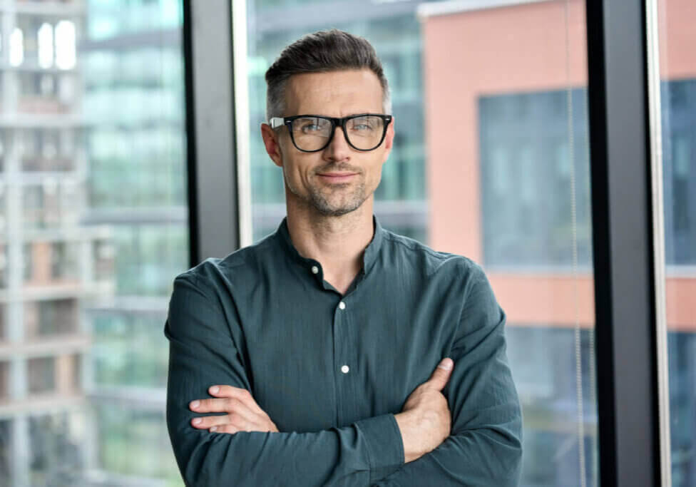 business professional smiling with black glasses on.