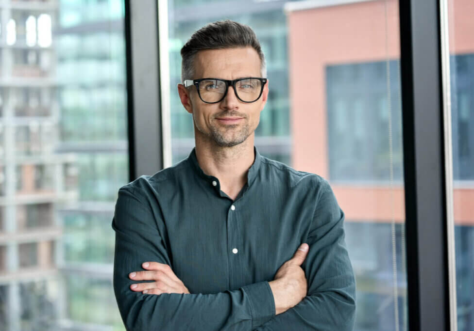 business professional smiling with black glasses on.