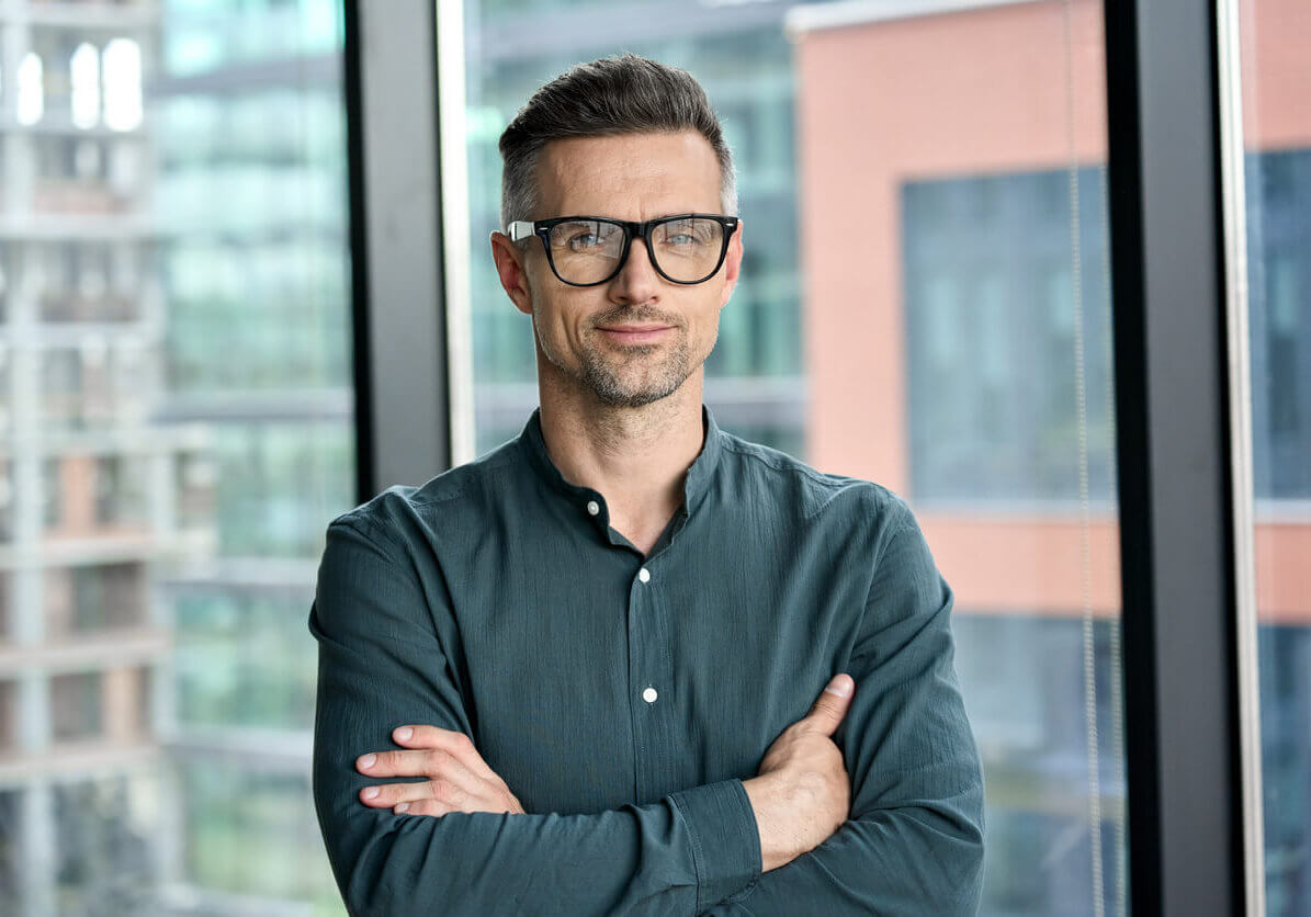 business professional smiling with black glasses on.