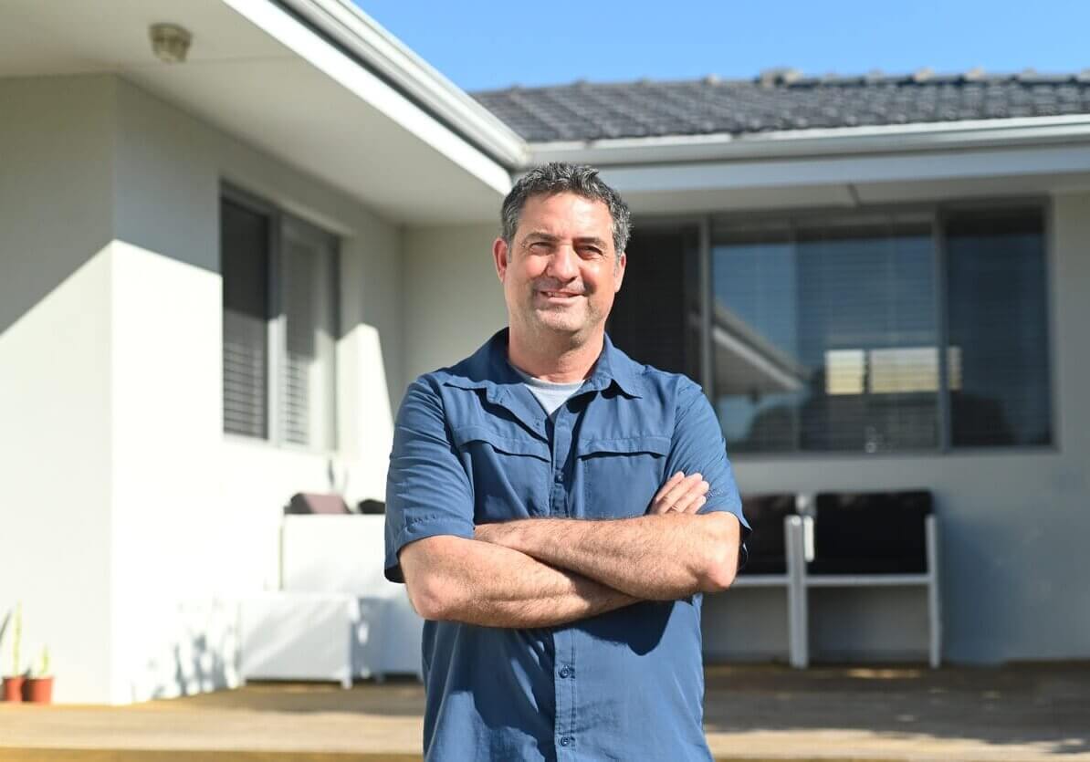blue collar worker standing happy with his arms crossed
