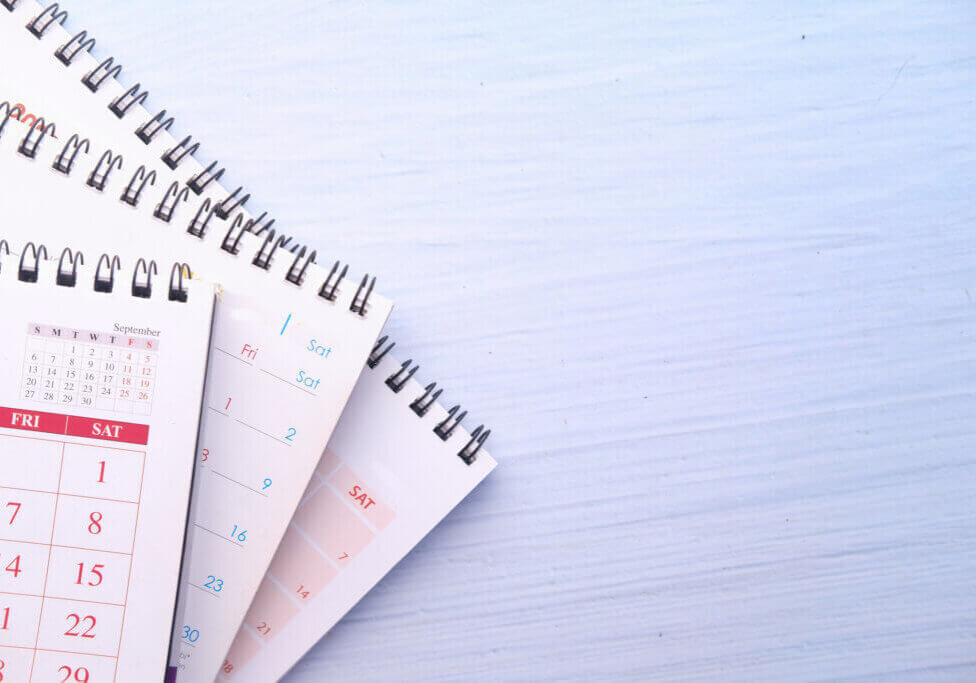 deadline concept with stack of calendar on table with copy space .