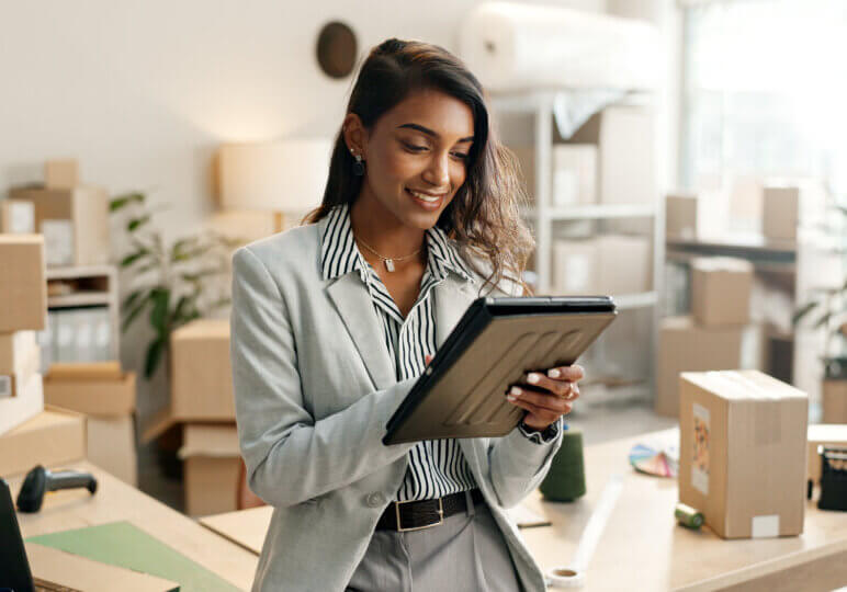 Small business, woman and tablet for e commerce, startup and inventory management of online shop, order or courier. Entrepreneur or Indian seller on digital technology for logistics, boxes or package